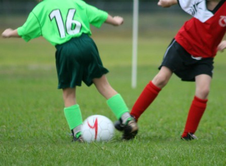 Children Playing Football At School